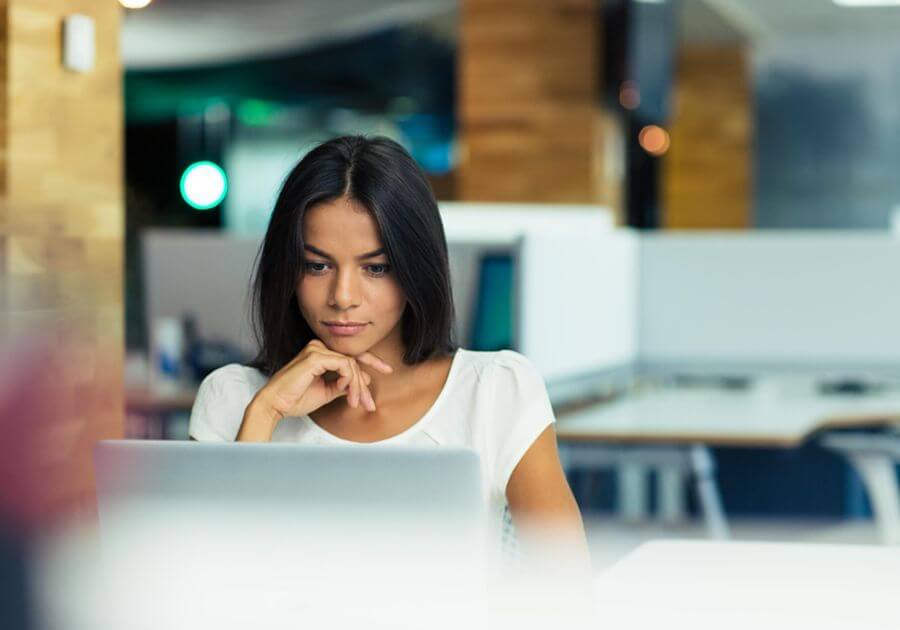 Portrait of a serious businesswoman using laptop in office